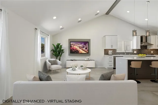 a living room with furniture kitchen view and a potted plant