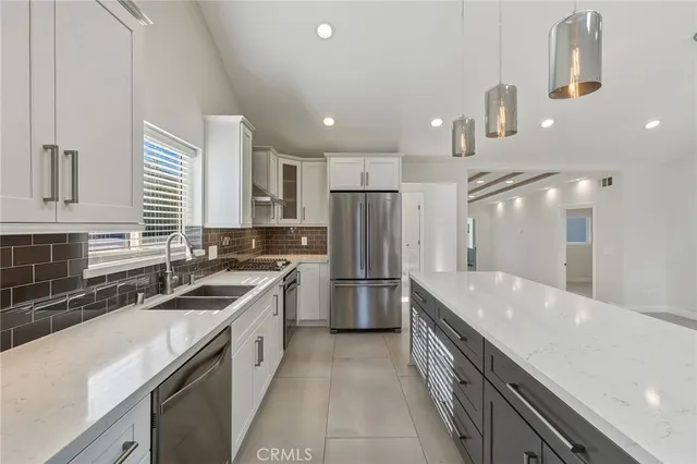 a kitchen with a sink stove and refrigerator