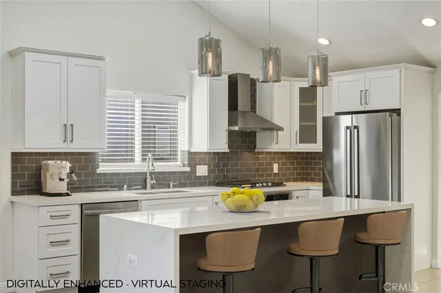 a kitchen with stainless steel appliances a sink stove and refrigerator