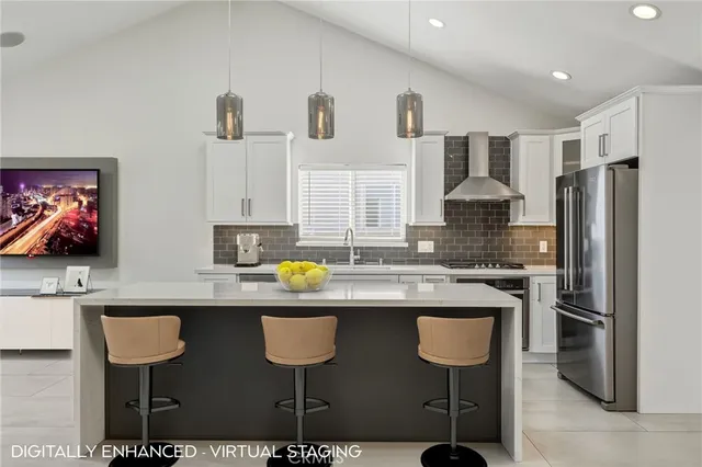 a kitchen with stainless steel appliances granite countertop a sink and a refrigerator