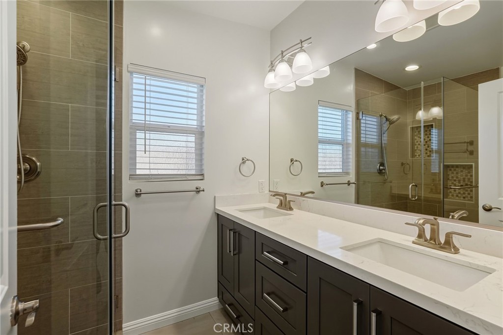 6017 Encino Encino, CA 91316 - Photo 21 of 51 a bathroom with double vanity and a mirror