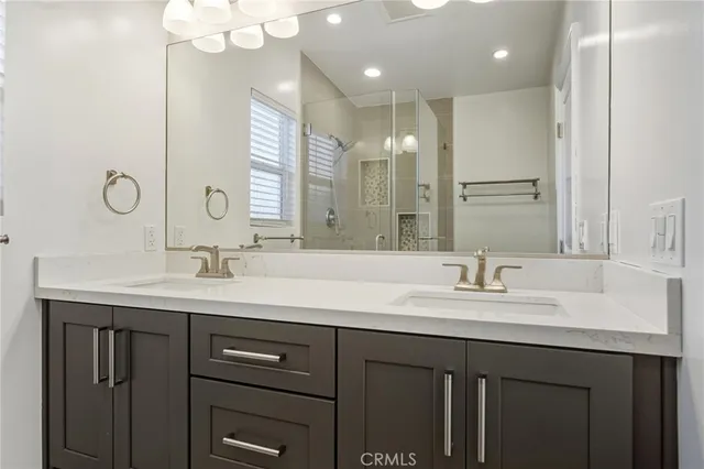 a bathroom with a double vanity sink and a mirror