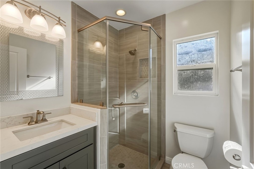 6017 Encino Encino, CA 91316 - Photo 26 of 51 a bathroom with a shower sink vanity mirror and toilet