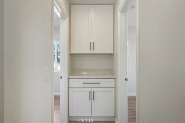 a view of kitchen with white cabinets