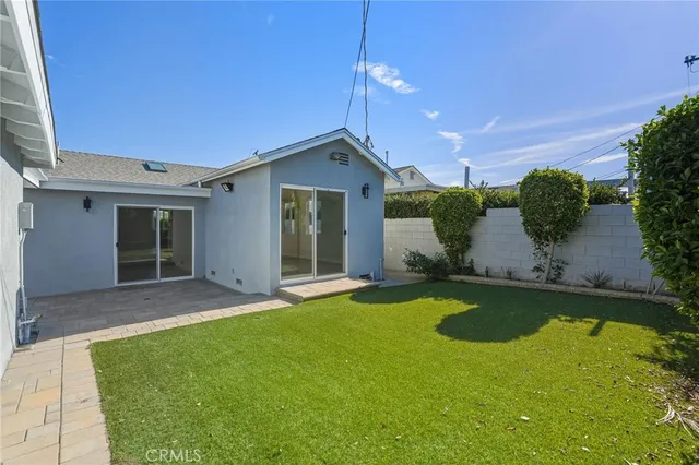 a view of a house with a swimming pool and a yard