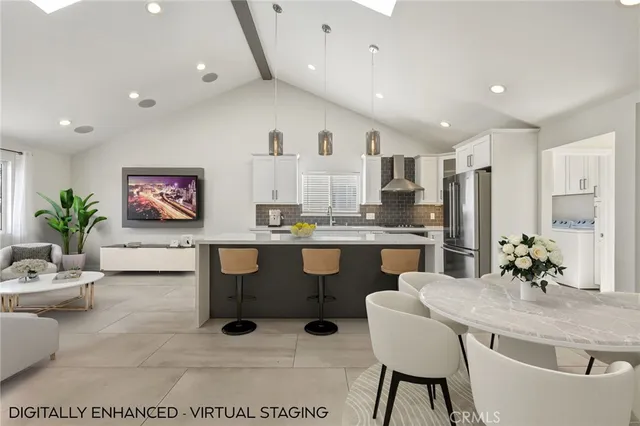 a living room with kitchen island furniture and a chandelier