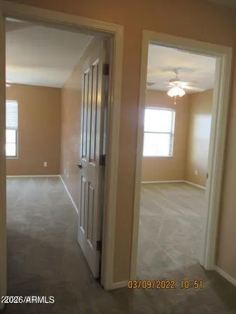 an empty room with windows and closet