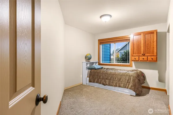 a bedroom with a bed and a window