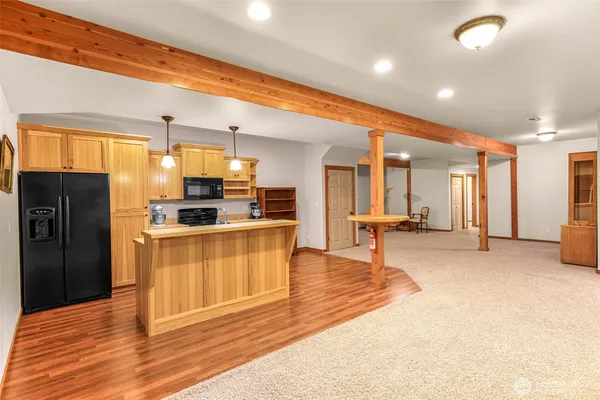 a kitchen with stainless steel appliances kitchen island granite countertop a refrigerator and stove top oven