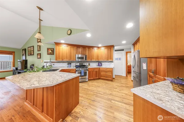 a kitchen with stainless steel appliances granite countertop counter top space a sink and cabinets