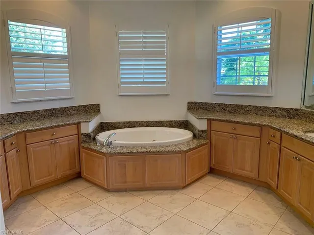 a bathroom with a granite countertop sink and mirror