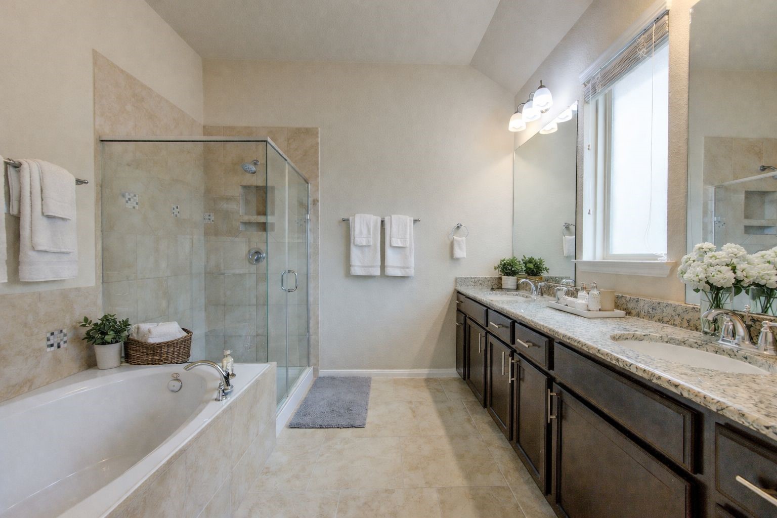 18106 Dorman Draw Lane Houston, TX 77044 - Photo 19 of 27 a spacious bathroom with a granite countertop tub sink and mirror