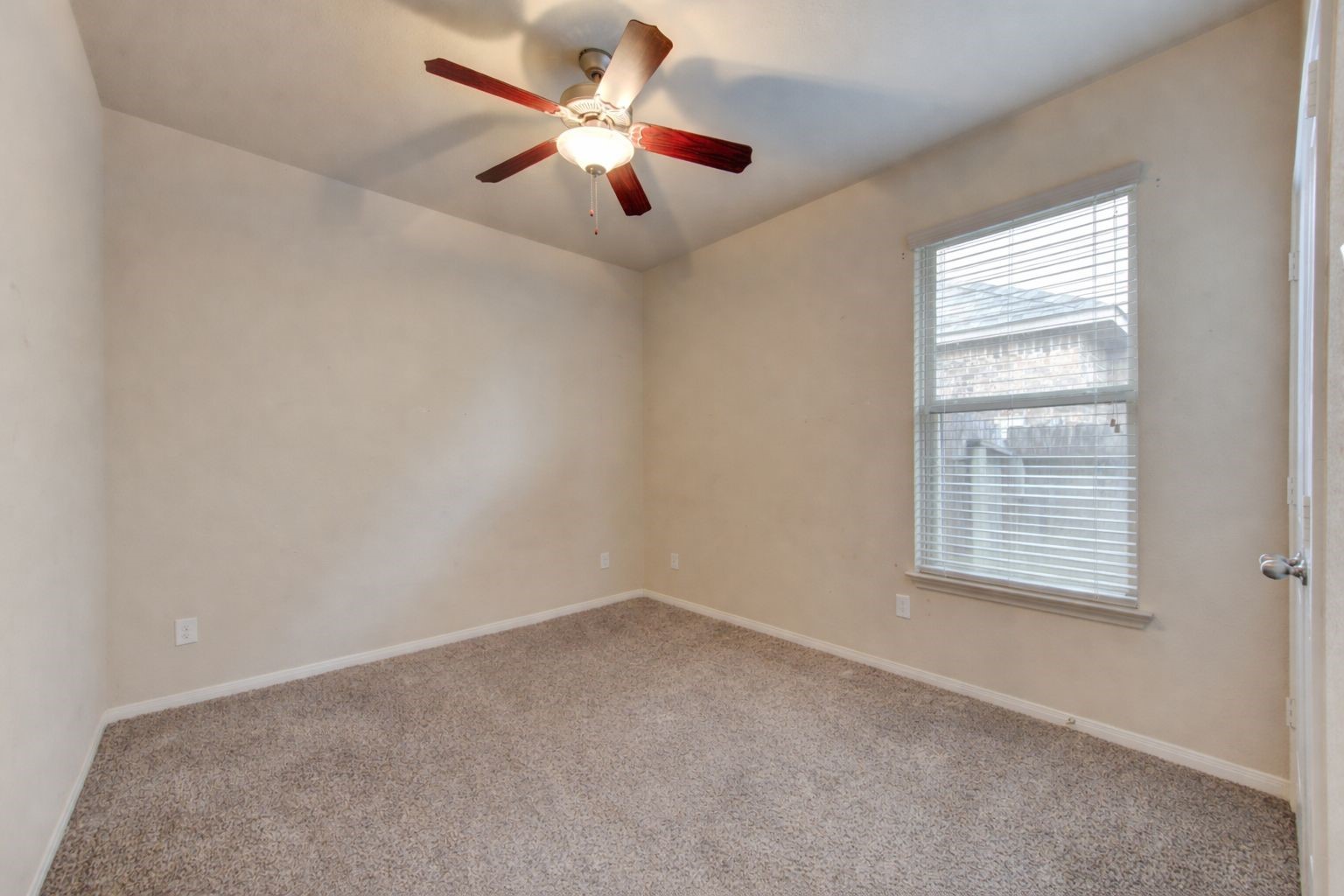 18106 Dorman Draw Lane Houston, TX 77044 - Photo 23 of 27 an empty room with a window and a fan