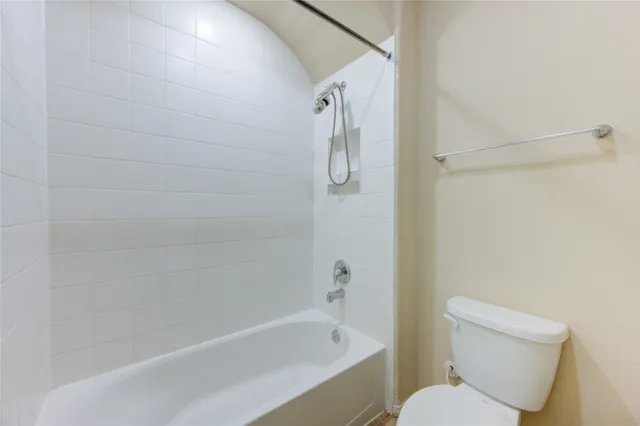 a bathroom with a toilet and a bathtub
