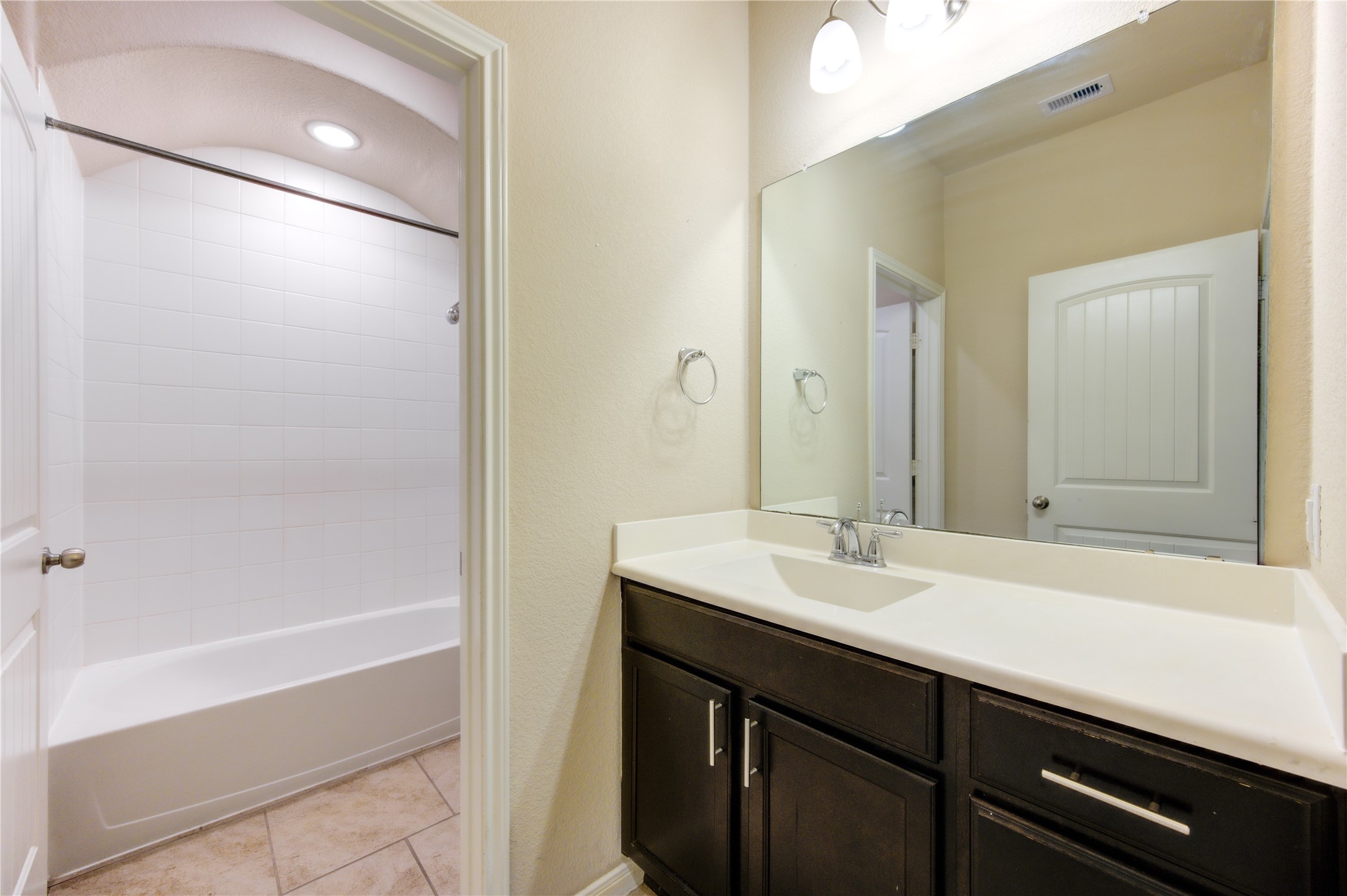 18106 Dorman Draw Lane Houston, TX 77044 - Photo 25 of 27 a bathroom with a sink a shower and a mirror