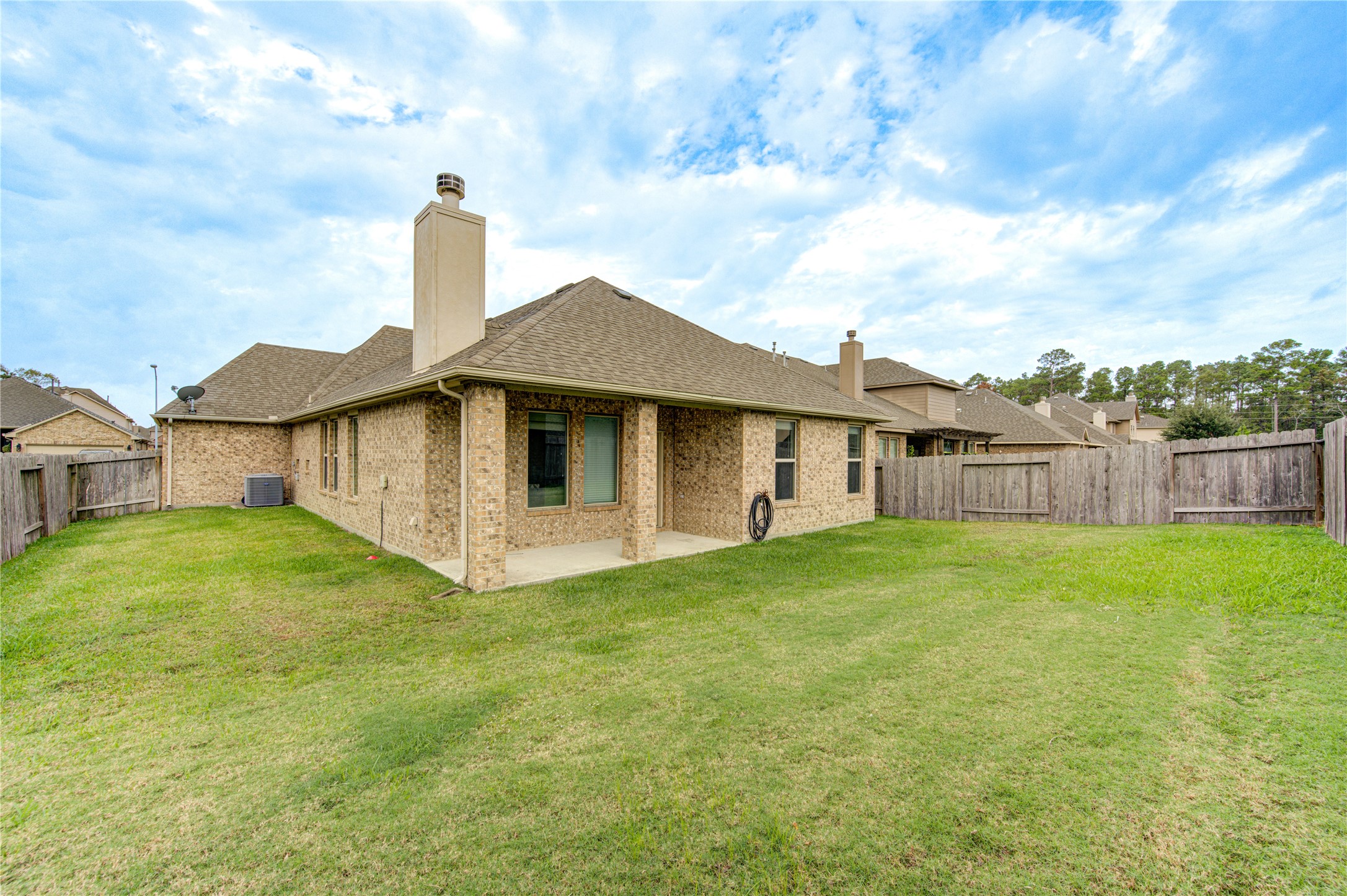18106 Dorman Draw Lane Houston, TX 77044 - Photo 27 of 27 a view of a house with a yard and sitting area
