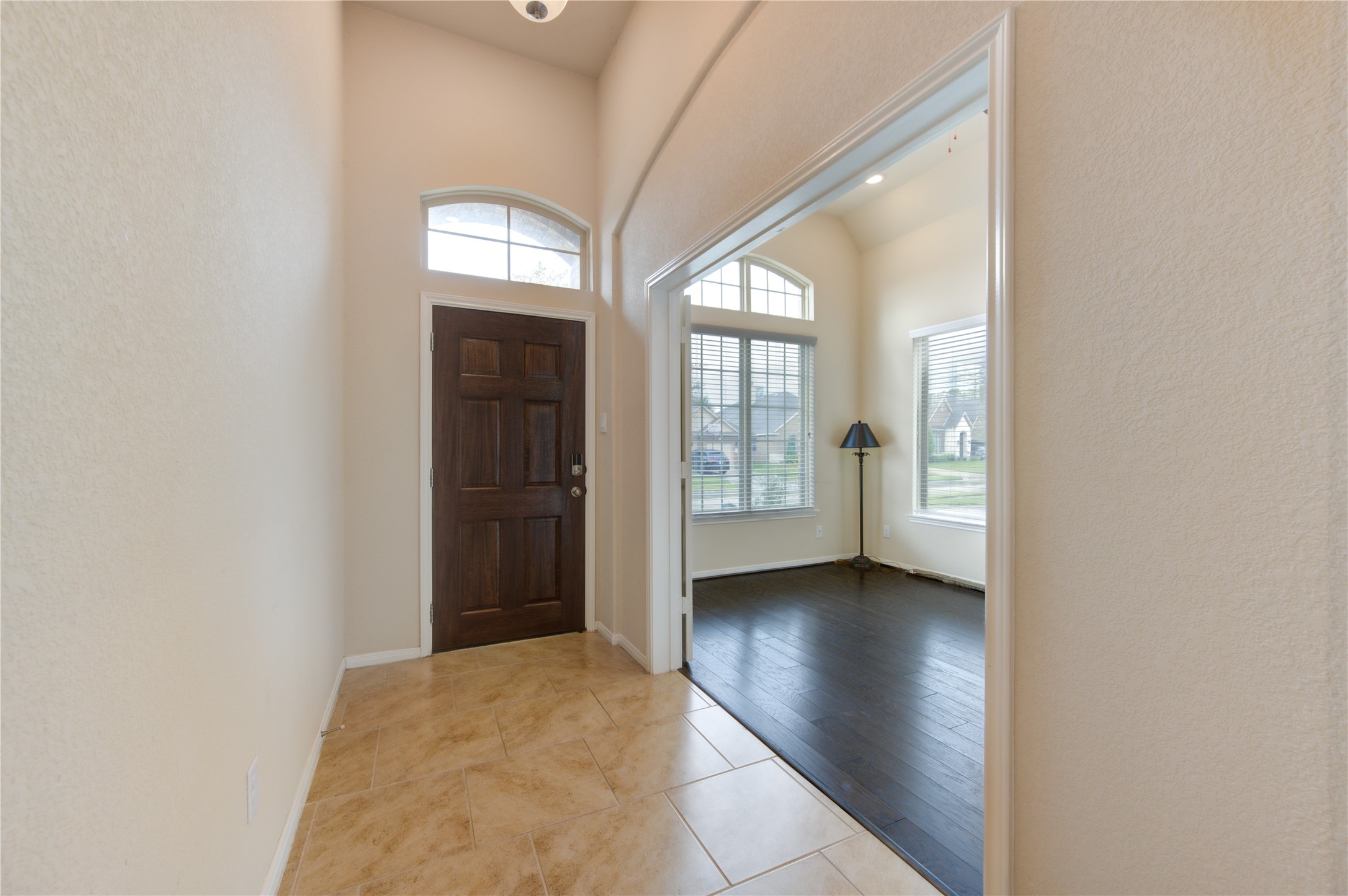 18106 Dorman Draw Lane Houston, TX 77044 - Photo 4 of 27 an empty room with windows and entrance