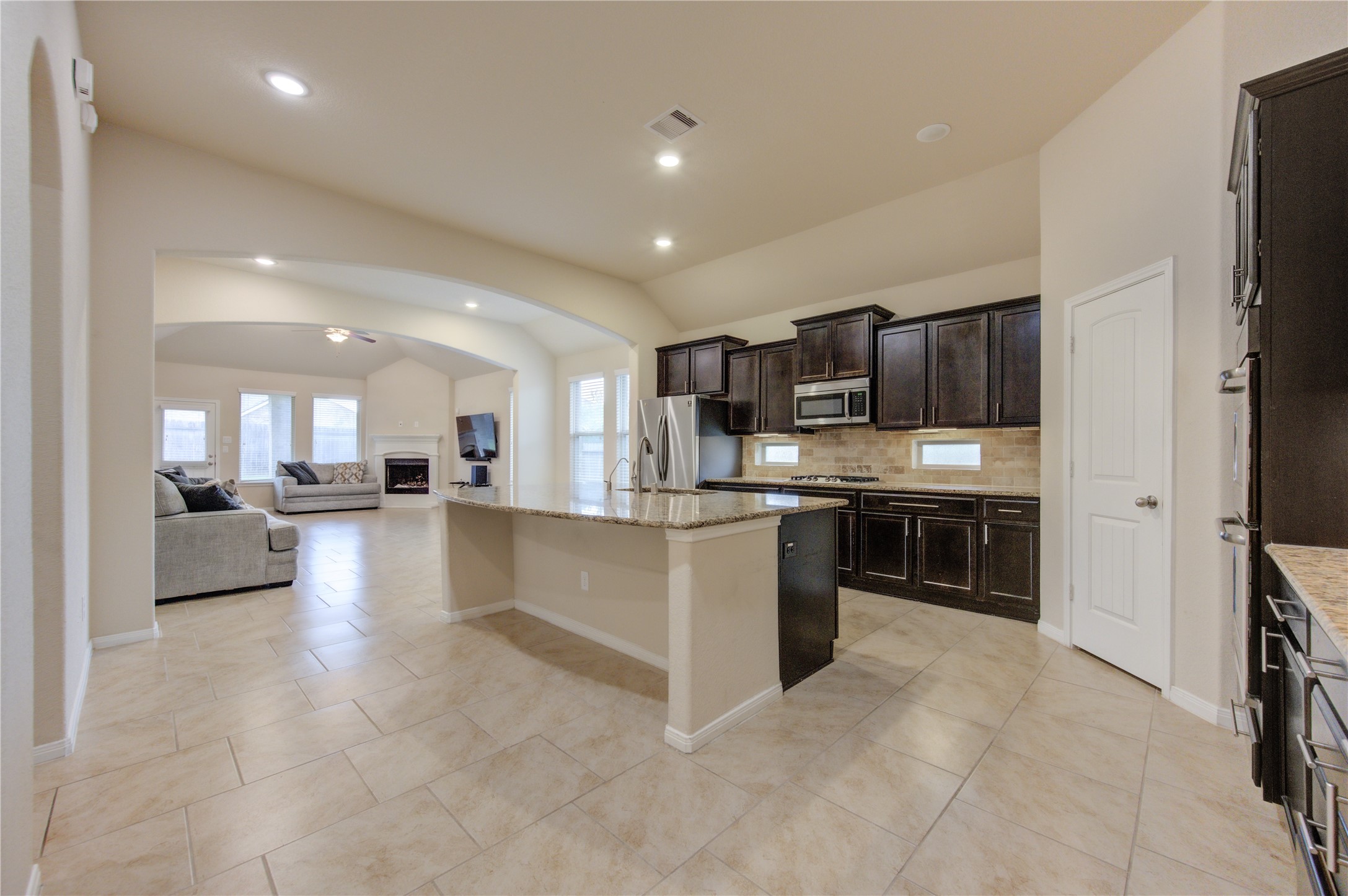 18106 Dorman Draw Lane Houston, TX 77044 - Photo 8 of 27 a view of kitchen with kitchen island stainless steel appliances refrigerator sink and stove