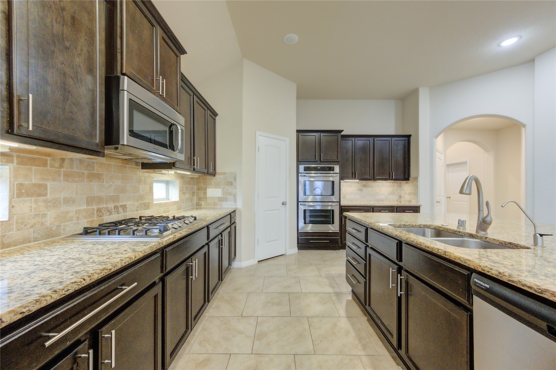 18106 Dorman Draw Lane Houston, TX 77044 - Photo 10 of 27 a kitchen with stainless steel appliances granite countertop a sink stove and refrigerator