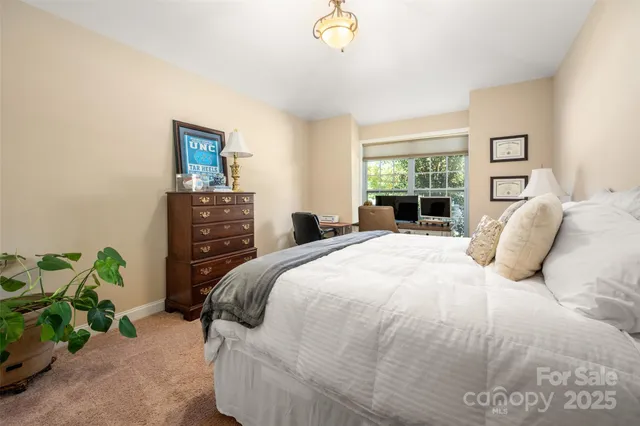 a bedroom with a bed and a potted plant