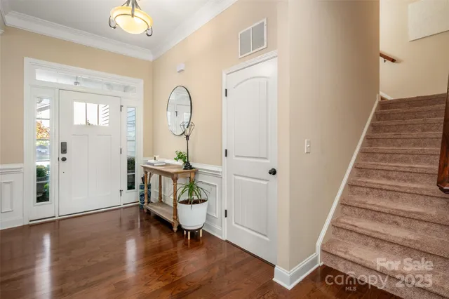 a view of a livingroom with wooden floor and furniture