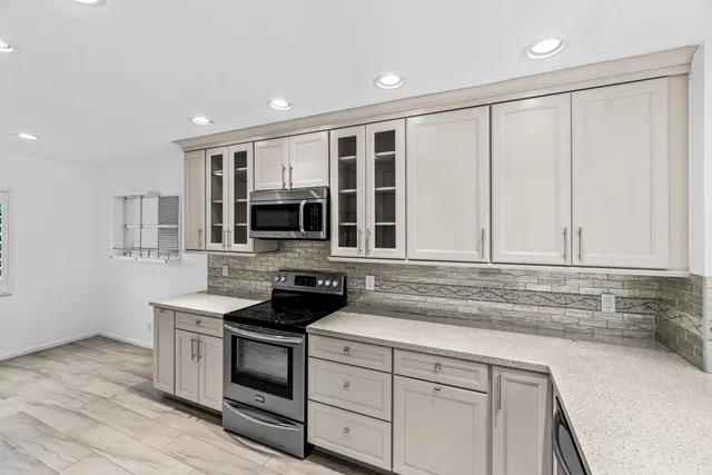 a kitchen with stainless steel appliances granite countertop a stove and a sink