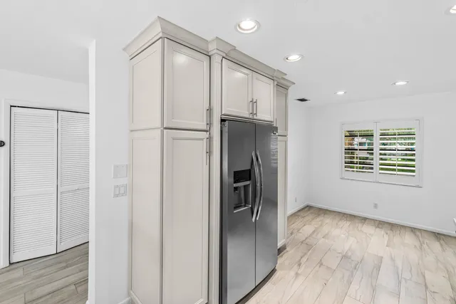 a view of a refrigerator in kitchen and wooden floor