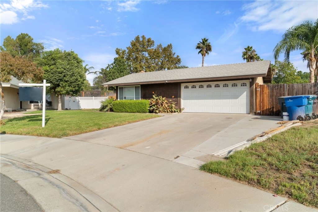 6934 Miami Street Riverside, CA 92506 - Photo 1 of 1 a front view of a house with a yard and garage