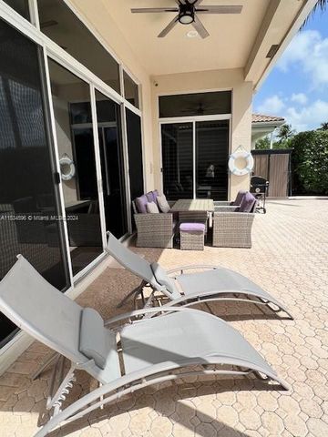 a view of a house with swimming pool and sitting area