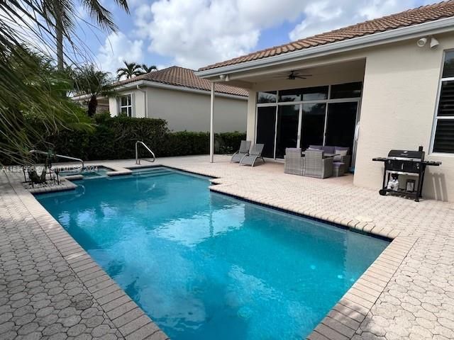 a backyard of a house with a yard and outdoor seating