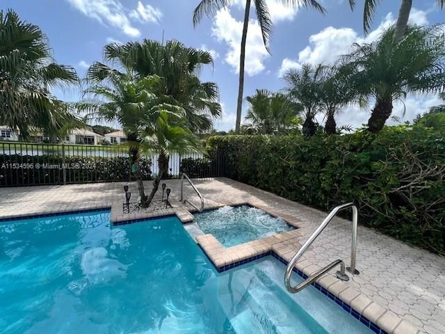 a view of a bedroom with furniture and windows