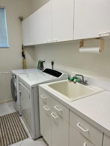 a living room with furniture a chandelier and a fireplace
