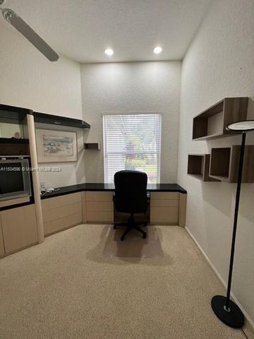 a view of backyard with seating area and trees in the background