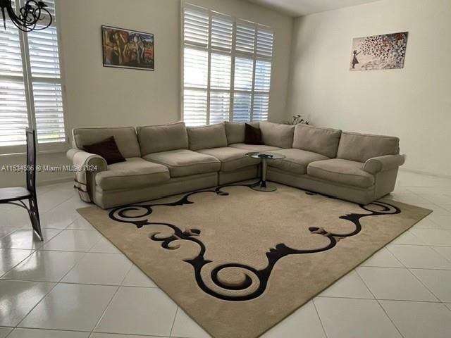 a living room with furniture and a chandelier