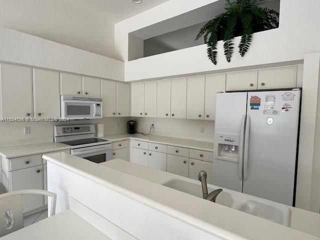 a kitchen with a sink a stove and refrigerator