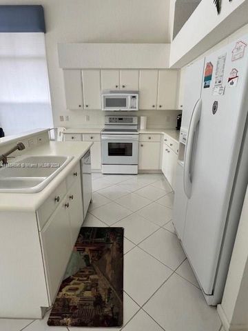 a kitchen with a sink and large window