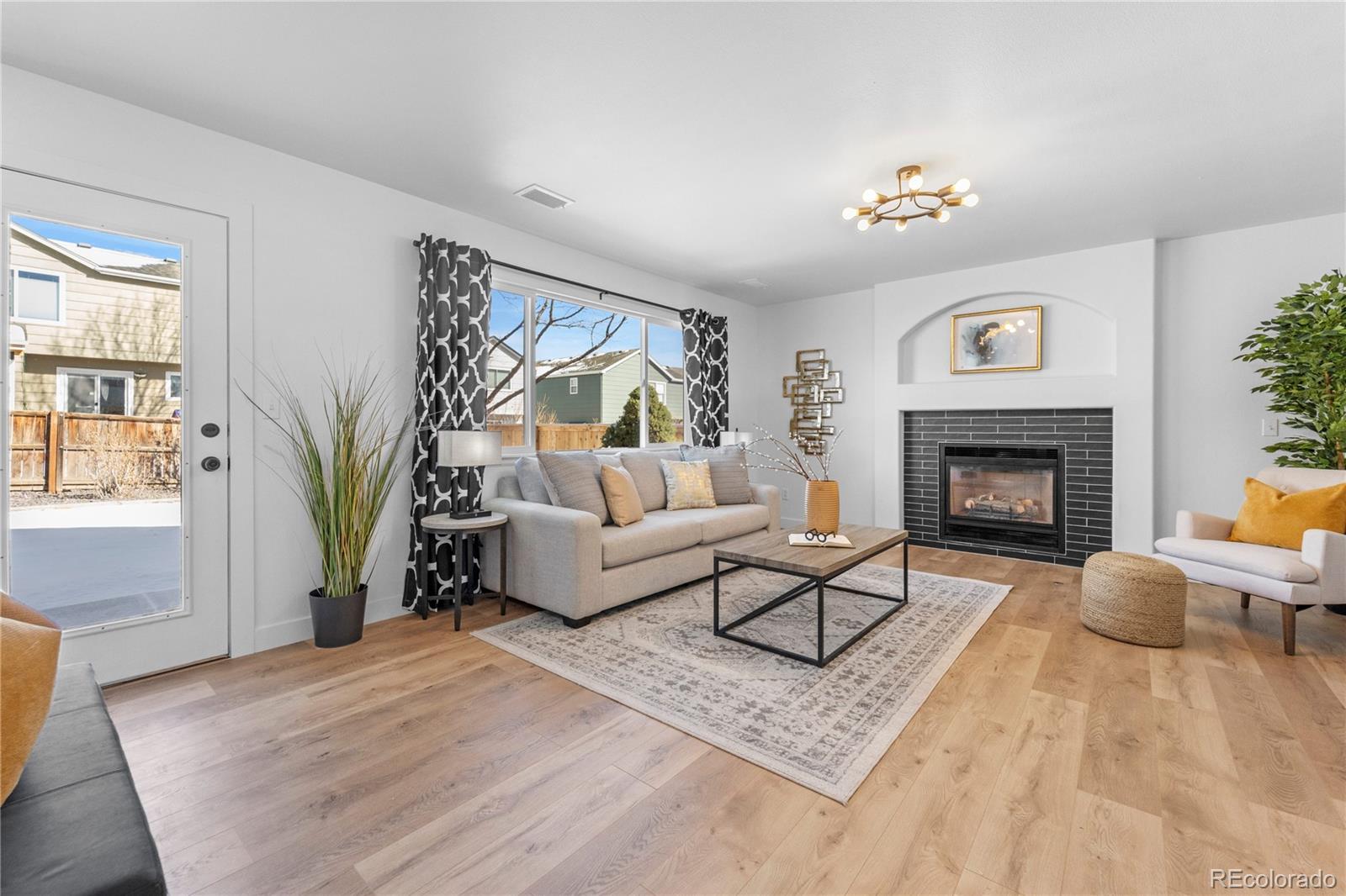 4865 Apollo Bay Drive Highlands Ranch, CO 80130 - Photo 15 of 38 a living room with furniture and a fireplace