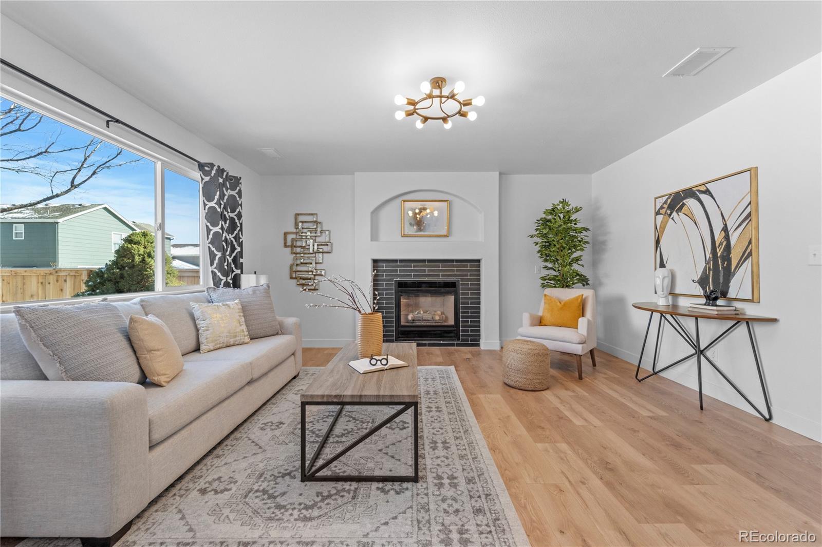 4865 Apollo Bay Drive Highlands Ranch, CO 80130 - Photo 16 of 38 a living room with furniture and a fireplace