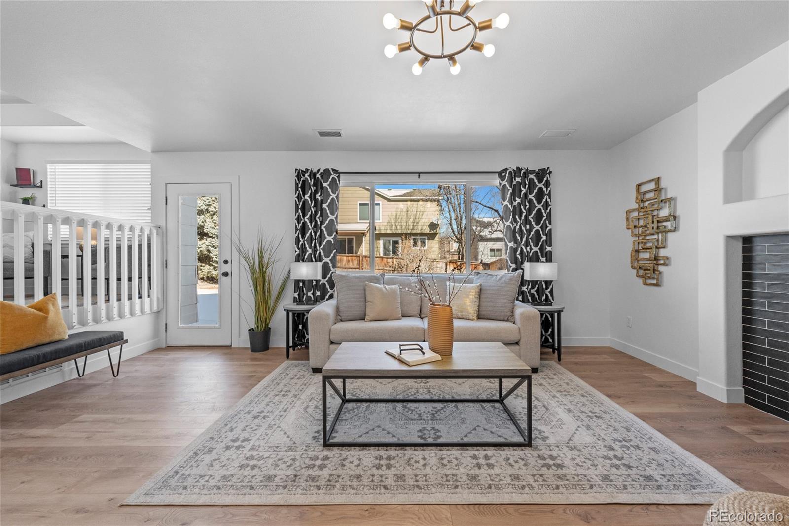 4865 Apollo Bay Drive Highlands Ranch, CO 80130 - Photo 17 of 38 a living room with furniture and a rug