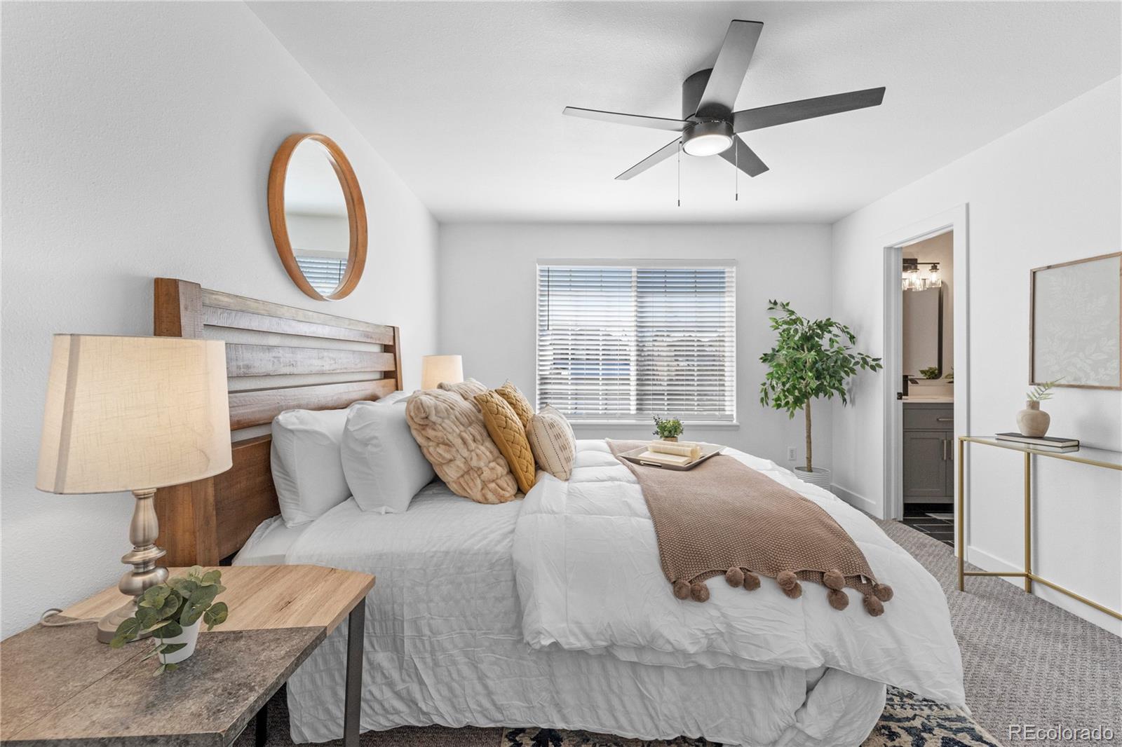4865 Apollo Bay Drive Highlands Ranch, CO 80130 - Photo 21 of 38 a bedroom with a bed and a potted plant