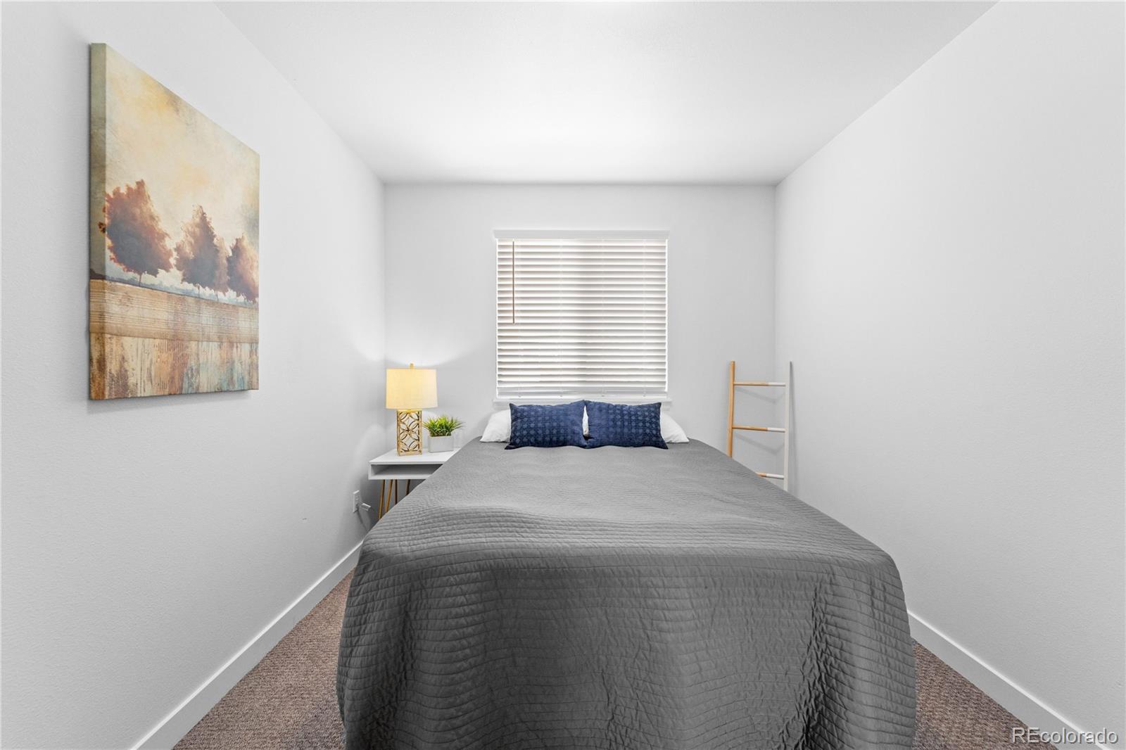 4865 Apollo Bay Drive Highlands Ranch, CO 80130 - Photo 25 of 38 a bedroom with a bed and window
