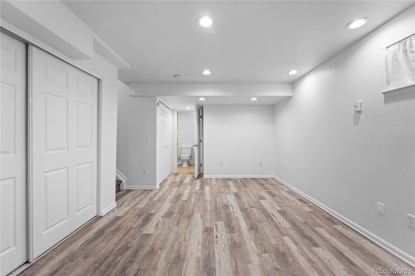 4865 Apollo Bay Drive Highlands Ranch, CO 80130 - Photo 28 of 38 a view of empty room with wooden floor