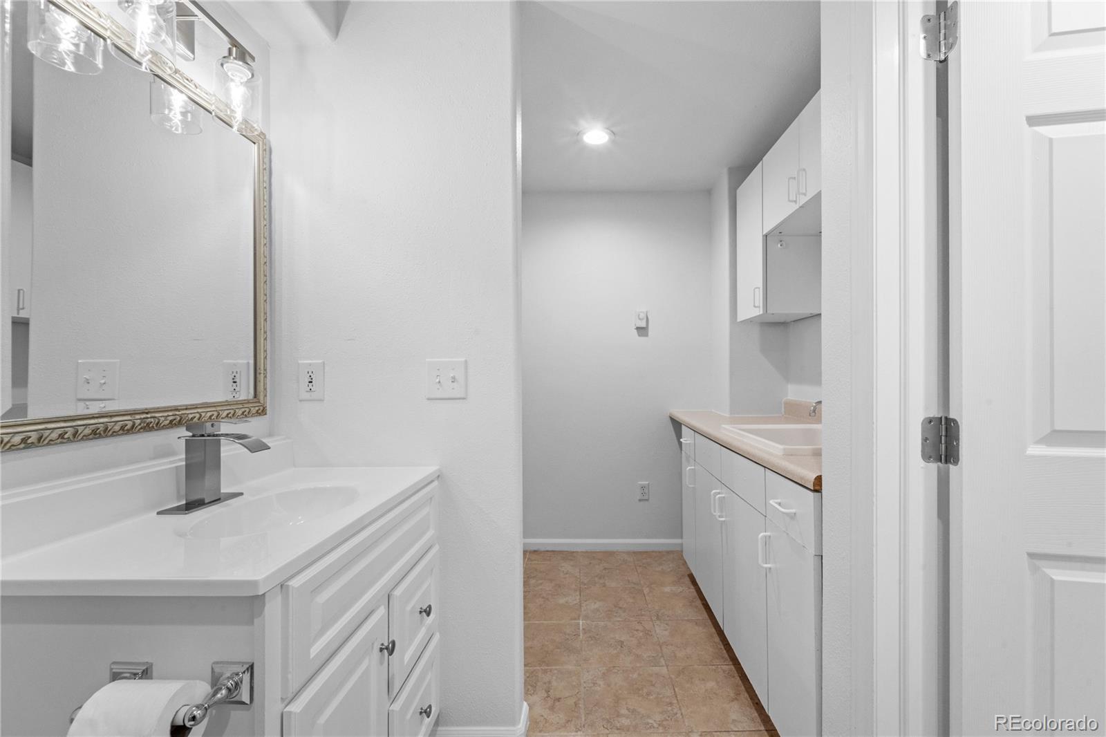 4865 Apollo Bay Drive Highlands Ranch, CO 80130 - Photo 29 of 38 a bathroom with a sink and a mirror