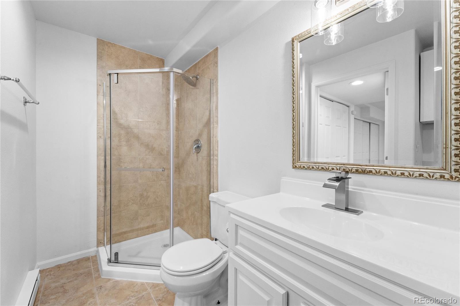 4865 Apollo Bay Drive Highlands Ranch, CO 80130 - Photo 30 of 38 a bathroom with a sink a toilet and a mirror