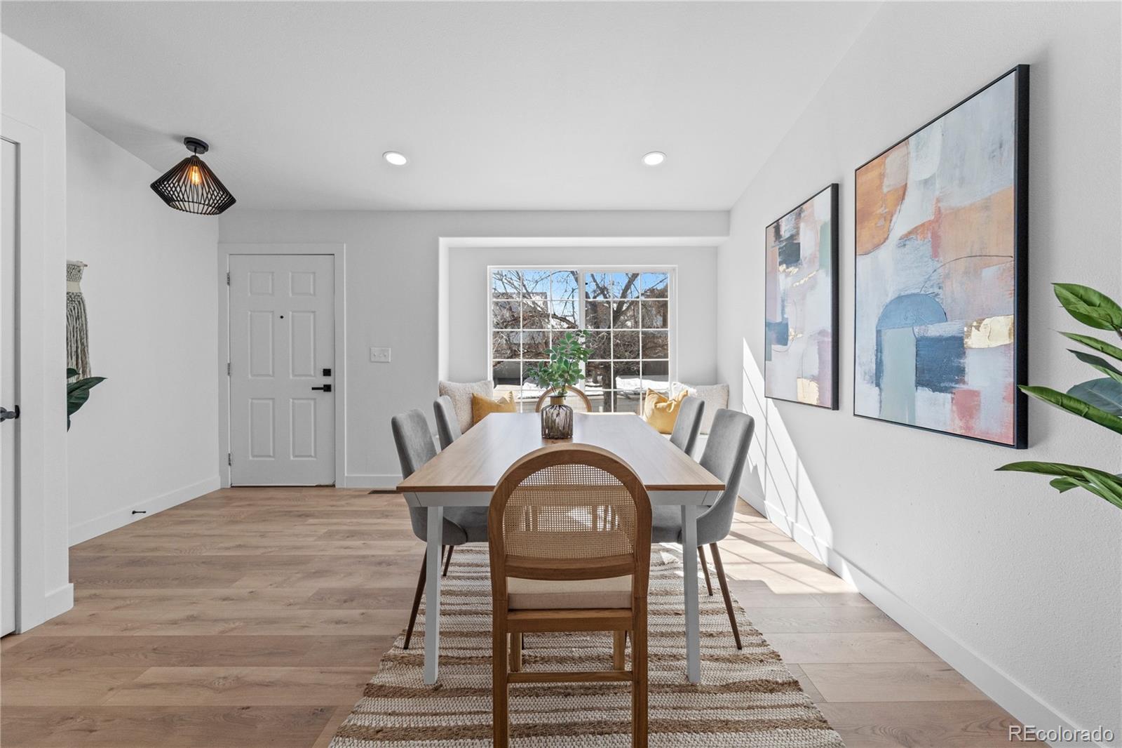 4865 Apollo Bay Drive Highlands Ranch, CO 80130 - Photo 7 of 38 a view of a dining room with furniture window and wooden floor