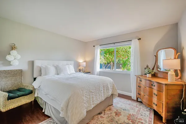 a bedroom with a bed and a large window
