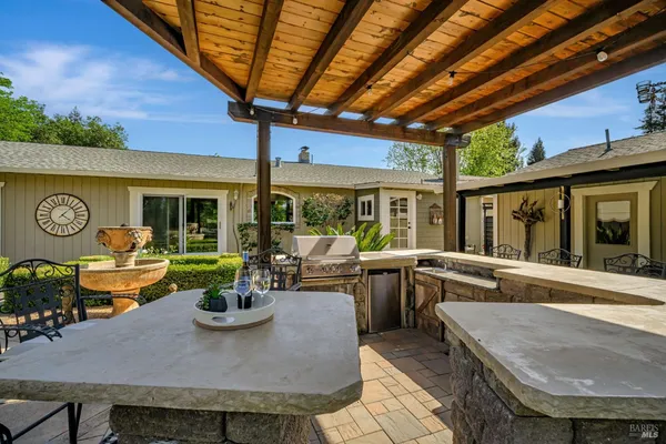 a outdoor dining space with furniture and garden view