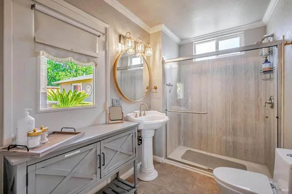 a bathroom with a sink mirror vanity and toilet
