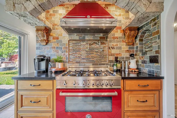 a kitchen with stainless steel appliances granite countertop a stove and a microwave