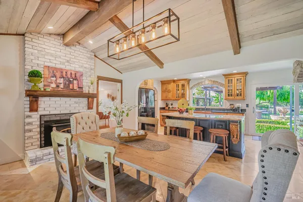a view of a dining room with furniture a chandelier and wooden floor